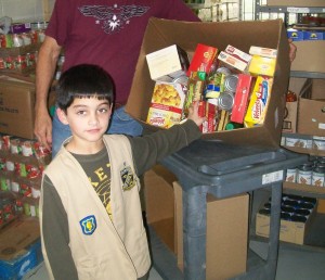 Matthew displays some of the food he collected for the pantry.