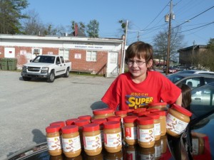 Rhyne displays some of the peanut butter jars he collected.